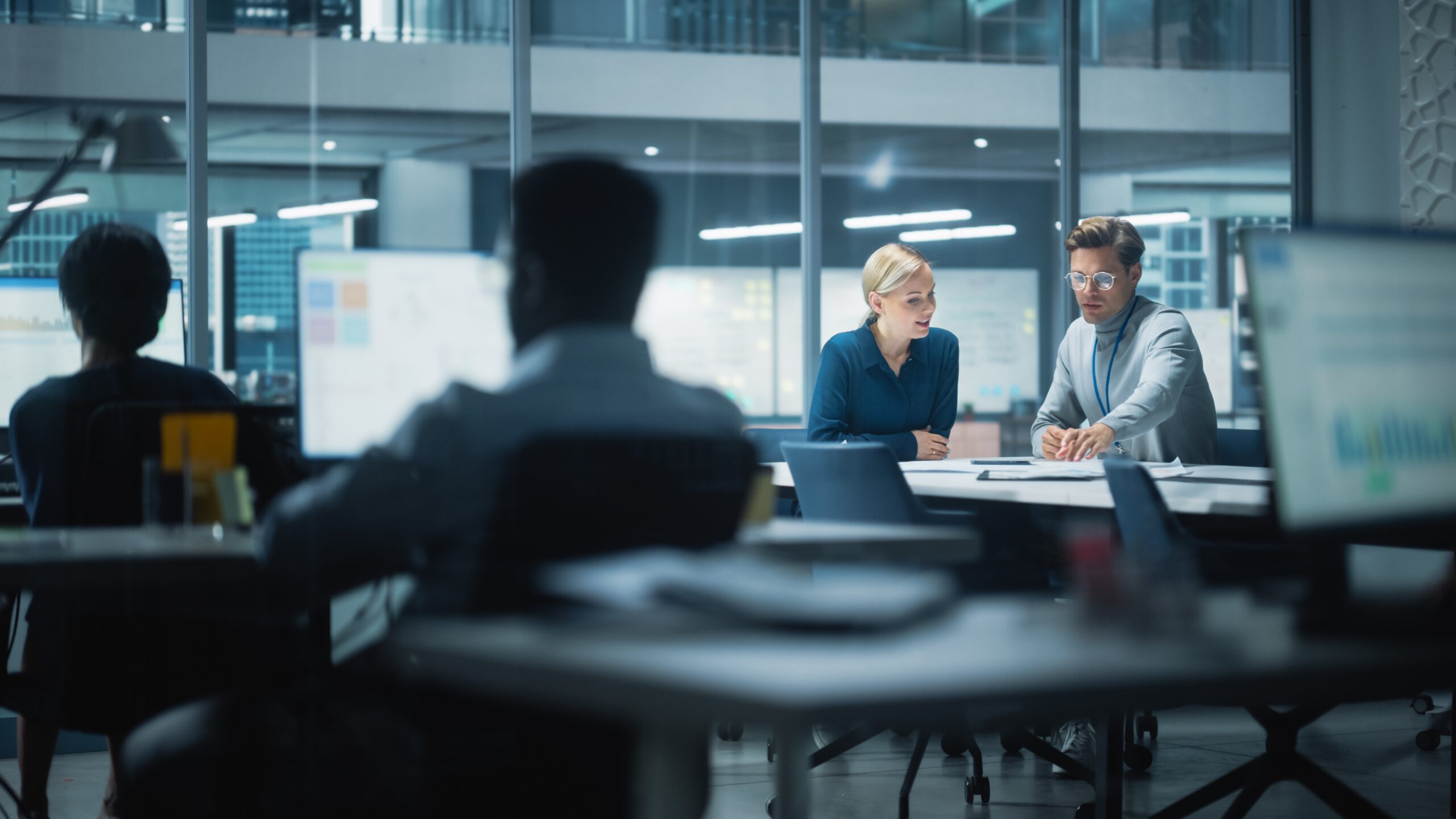 Two people sitting at a desk at work 