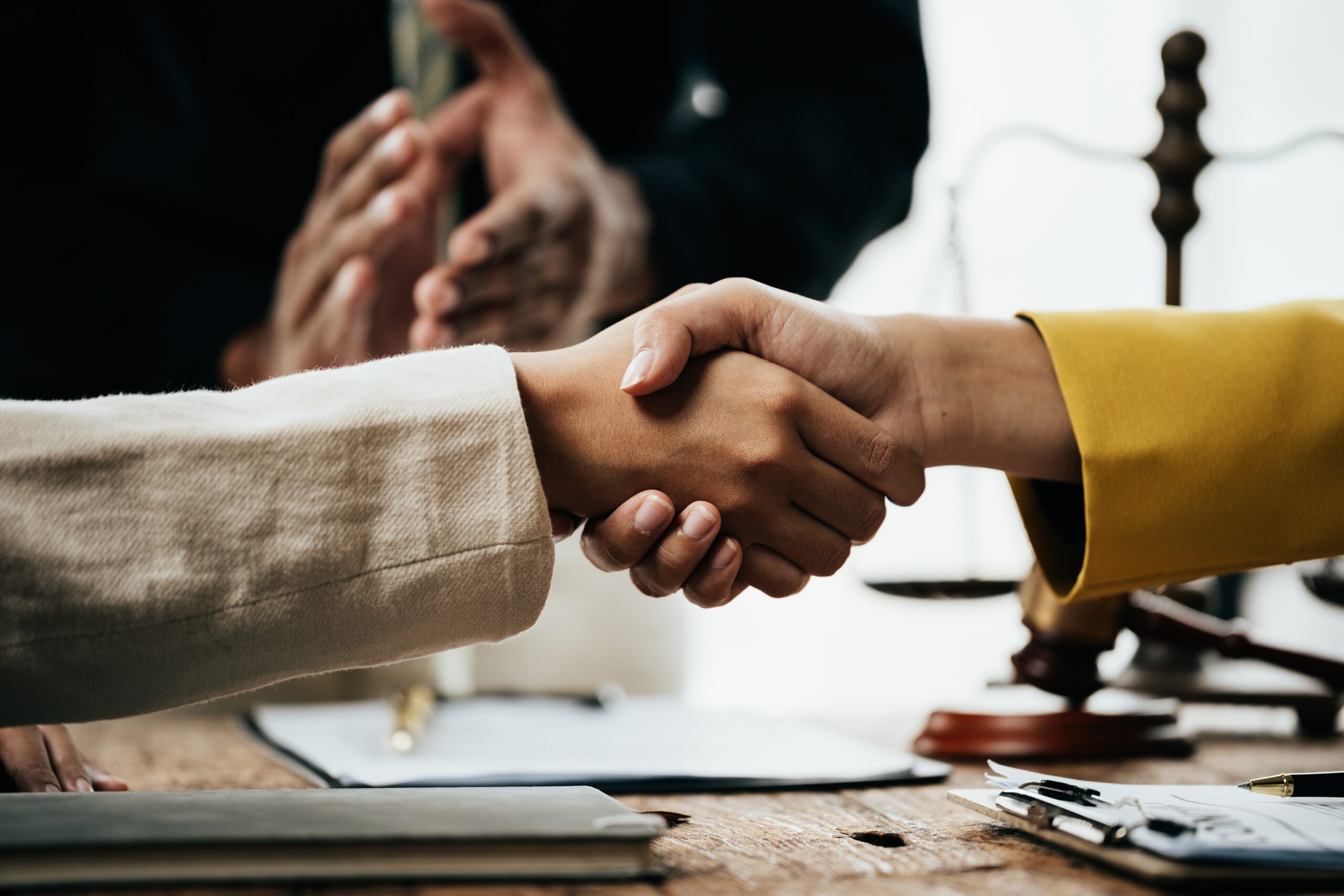 Illustrative photo of people shaking hands in a professional’s office 